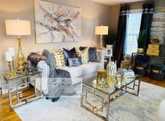 a living room filled with lots of furniture and gold accessories on top of a white rug