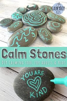 some rocks with chalk writing on them and the words calm stones written in blue ink