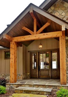 the front entrance to a home with stone steps