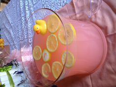 a pink liquid with lemons in it on a table