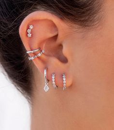 The Roslin are huggie hoop earrings with a pave cubic zirconia rhombus charm. These original, fancy, minimalist-style earrings are perfect to wear daily as well as on special occasions. Features: * Inner diameter: 9 mm. * Outer diameter: 12 mm. * They are sold in singles and pairs. Both options are available on the dropdown menu. * All of our jewelry is made of sterling silver (925 mm), and our gold jewelry is gold plated in 18K gold. Nickel free. Packaging: Our jewelry is packaged in a reusable Ear Piercing Designs For Small Ears, Conch Ear Piercings Hoop, Good Piercing Combinations, Silver Conch Hoop, Ear Piercings Inspo Classy, Silver Ear Styling, Ear Piercing Curation Silver, Silver Stacked Earrings, Silver Earring Stacks