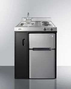 a silver and black refrigerator freezer sitting next to a sink in a white room