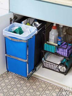 a kitchen cabinet with two bins filled with cleaning supplies and other items in it