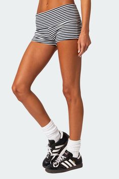 a woman in black and white striped shorts