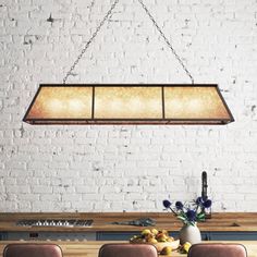 a dining room table with four chairs and a light fixture hanging from the ceiling over it