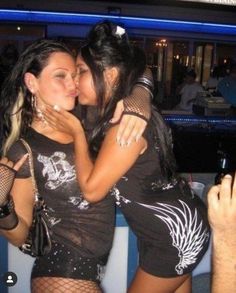 two women are hugging each other at a party