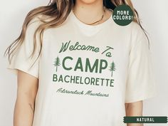 a woman wearing a t - shirt that says welcome to camp bachelor