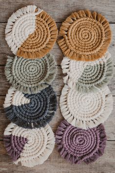 several circular rugs are arranged on a wooden surface