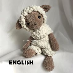 a small stuffed animal sitting on top of a white sheet with the words english written below it