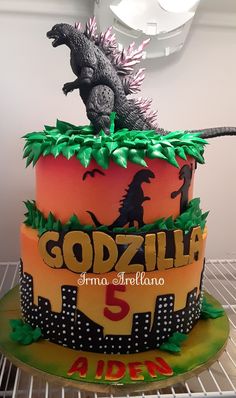 a birthday cake with godzilla on top
