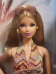 a close up of a barbie doll wearing sunglasses