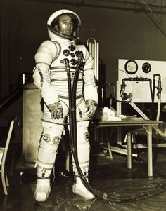 an astronaut standing in his space suit with a hose attached to it's chest