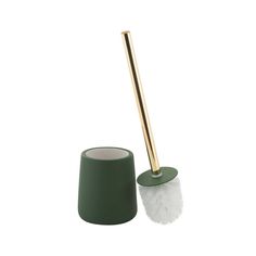 a toilet brush sitting next to a green cup