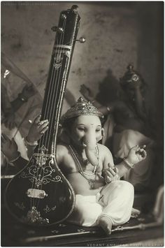 an elephant sitting next to a musical instrument