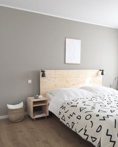 a bedroom with a bed, nightstand and window