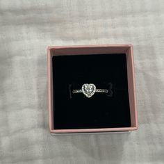 an engagement ring in a pink box