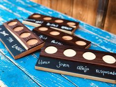 three wooden boxes with different types of eyeshades on them sitting on a blue table