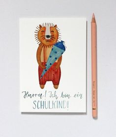 a card with a drawing of a bear holding a blue object next to a pencil