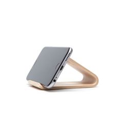 the wooden stand is holding an iphone in it's back end, and has a phone