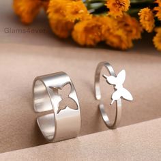 Reinvent your style and bring a breath of fresh air to your look with this set of two coordinated and adjustable rings. Their attractive design and butterfly decoration will captivate attention and fit into any style. 🌟 Composition: High-end 316L stainless steel with a gold finish. ☑️ Aesthetic design ☑️ Water resistant, does not fade ☑️ Anti-allergic ☑️ Eco-responsible: fully recyclable materials 🌟 Adjustable size: designed to easily fit each finger. These rings, both unique and matching, rep Matching Butterfly Rings, Butterfly Couple Rings, Butterfly Promise Rings, Matching Rings For Couples, Rings Butterfly, Couple Rings Silver, Matching Stuff, Butterfly Rings, Cute Promise Rings