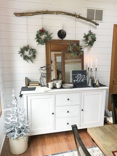 a white dresser with christmas decorations on top