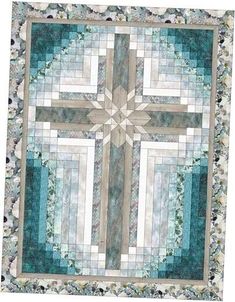 a quilted wall hanging with a large cross on it's center and sides