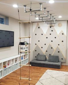 a living room filled with furniture and a flat screen tv mounted to the side of a wall