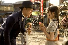 a man and woman eating food on the street