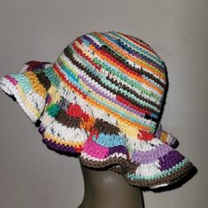 a crocheted multicolored hat sitting on top of a mannequin head