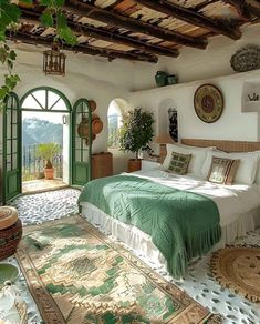 a bedroom with a bed, rugs and potted plants on the floor in front of an open door