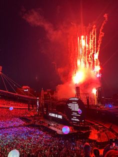 fireworks are lit up in the night sky at a concert