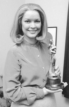 the woman is posing with her award for best performance in a musical play, which she won