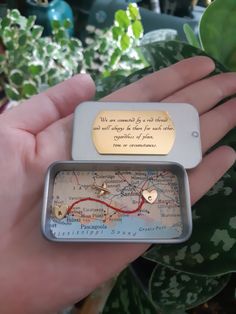 a person holding a small map with a quote on it