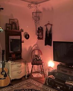 a living room filled with furniture and a flat screen tv sitting on top of a wooden dresser