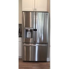 a large stainless steel refrigerator in a kitchen