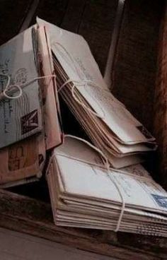 several envelopes tied together in a wooden box