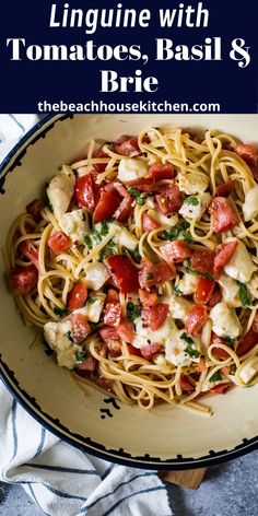 linguinne with tomatoes, basil and brie in a bowl on top of a table