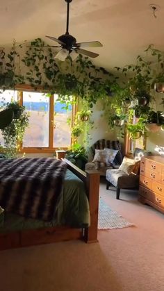 a bed room with a neatly made bed and lots of plants