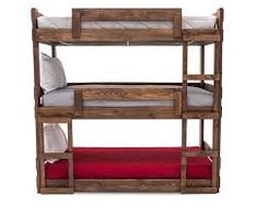 a wooden bunk bed with two red pillows