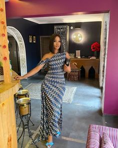 a woman in a blue and white patterned dress