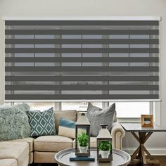 a living room filled with furniture and a window covered in blinds