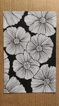 some black and white flowers on a cardboard box