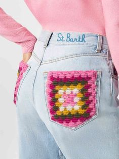 the back of a woman's jeans with an embroidered pocket