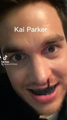 a man with a fake moustache on his face and the words kai parker above him