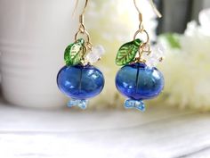 "glass blueberry drop earrings with cute green leaf and flower Material: glass ball beads, glass leaf, glass flower drop length: about 1.5\" Contains small parts. Use caution when giving to young children less than Age 3 Please keep them away from moisture. If you have any questions, please feel free to contact me. Thanks :)" Blueberry Dress Aesthetic, Blue Berry Earrings, Glass Flower Beads, Blueberry Accessories, Blueberry Dress, Blueberry Earrings, Earrings Food, Glass Bubble, Nature Earrings