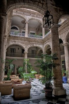 an indoor courtyard with couches and chairs