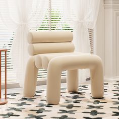 three pieces of furniture sitting on top of a tiled floor next to a window with white curtains