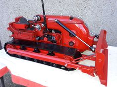 a red machine sitting on top of a white table