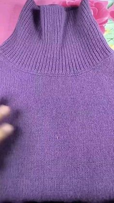 someone is cutting out the back of a purple sweater