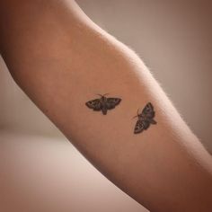 two moths tattoo on the left arm